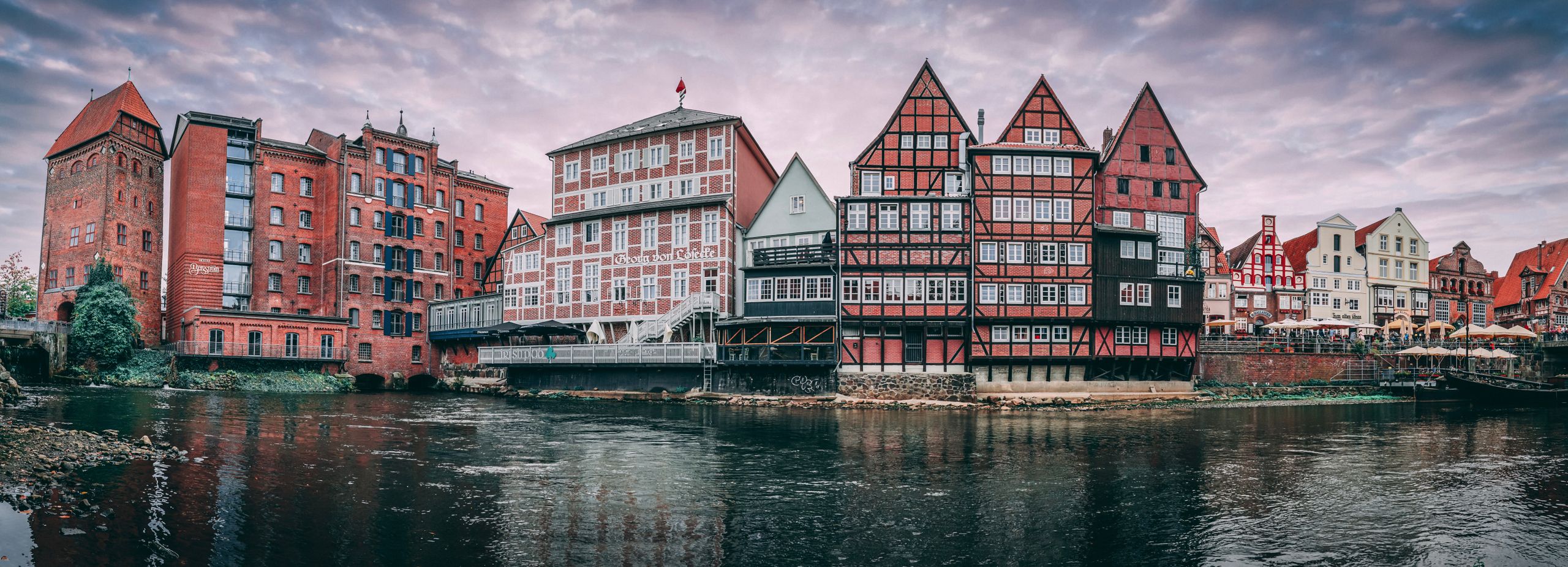 Panoramic view of traditional buildings along the river in Lüneburg, Germany.